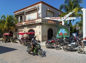 Street scene with motorcycle vehicles in centre of small settlement of Celestun, Yucatan, Mexico,