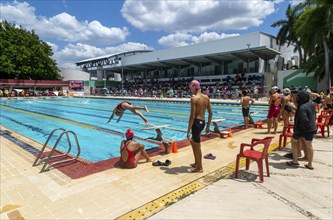 Young people at swimming pool gala event, relay race in progress, Campeche city, Campeche State,