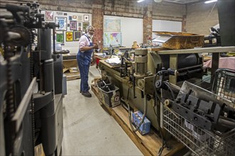 Detroit, Michigan, Amos Kennedy works in his letterpress printing shop. Kennedy prints posters and