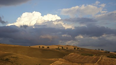 Evening light, Autumn hill landscape, brown fields, dramatic cloudy sky, Madonie National Park,