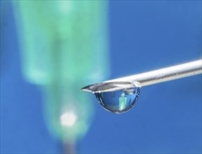 Macro image Covid vaccine, a drop of Moderna vaccine hangs on a vaccine needle