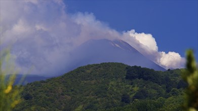 Cloud-shrouded peak, blue sky, green mountain slopes, Etna, volcano, Eastern Sicily, Sicily, Italy,