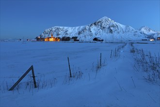 Flakstad church, behind it the mountain Hustinden (691m)