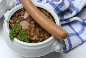 Lentil (Lens culinaris) dish with sausages in bowl, lentil