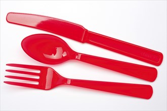 Disposable cutlery, red plastic cutlery, plastic knife, plastic fork, plastic spoon