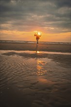 Tourist on the beach at sunset, Zandvoort, Netherlands