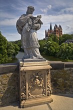 Statue of the bridge saint Nepomuk on the Old Lahn Bridge with Limburg Cathedral St. George,