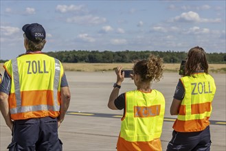 Customs officers wearing high-visibility waistcoats, Schönefeld Airport apron, Brandenburg,