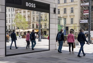 Pedestrians reflected in a shop window, Kärntner Strasse at Donnerbrunnen, Vienna, Austria, Europe