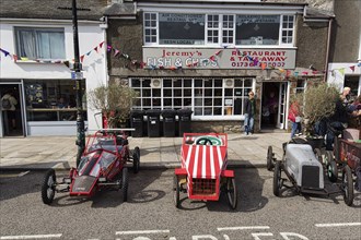 Traditional soapboxes parked by the roadside in the town centre, Lafrowda Festival 2023, St Just in