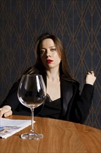 Portrait of stylish woman in jacket with empty wine glass