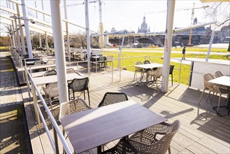 The Elbsegler's restaurant tables lie deserted in the first spring light on the banks of the Elbe