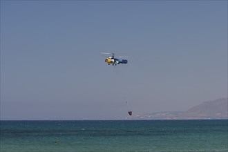 Helicopter, helicopter, fire-fighting helicopter, fire, helicopter close above the water surface,