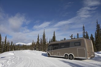 Travelling by motorhome in wintery Pallas Ylläastunturi National Park, Lapland, Finland, Europe