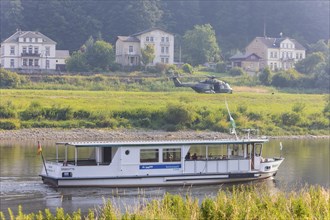 A Bundeswehr helicopter lands on the Elbe meadows in Bad Schandau on the Elbe, after a day of