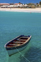 Rowboat in blue sea at coast. Santa Maria. Sal. Cabo Verde. Africa