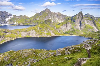 Mountain landscape with steep rocky peaks and lakes Tennesvatnet and Krokvatnet, in the back peak