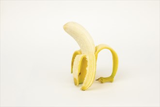 Half peeled banana, studio shot, white background, healthy diet