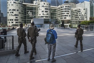 Rapid reaction soldiers control La Défense square, modern high-rise district in Paris, France,