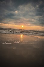 Beach with waves by the sea at sunset, Zandvoort, Netherlands