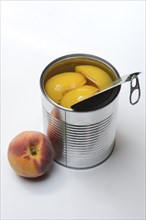 Peach, preserved peach halves with syrup in a tin can