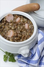 Lentil (Lens culinaris) dish with sausages in bowl, lentil