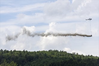 Symbolic image, climate change, helicopter, helicopter spreading finely painted limestone and wood