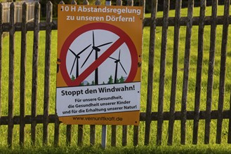 Poster of wind power opponents on a garden fence