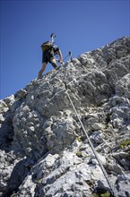 Climbers ascending the via ferrata to the summit of Lärchegg in the Wilder Kaiser, Tyrol, Austria,