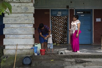 Meitei community man stays in a makeshift shelter after a mob burn their houses during an ethnic