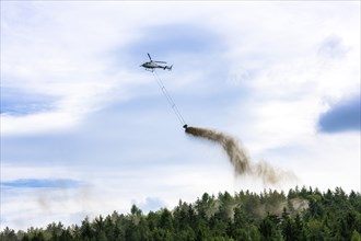 Symbolic image, climate change, helicopter, helicopter spreading finely painted limestone and wood