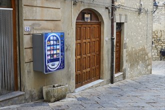 Colourful condom vending machine on historic building, Petralia Soprana, village in the National