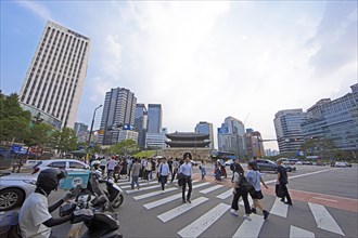 Koreans crossing the street, the historic Namdaemun City Gate or Great South Gate in the back and