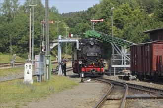 Steam locomotive of the Fichtelbergbahn filling at the water crane, railway tracks, station,