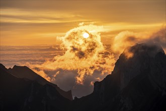 Sunrise, sun shining over mountains in fog, Säntis, Appenzell Ausserrhoden, Appenzell Alps,