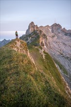 Hiker at the summit, mountains at sunrise, Säntis, Appenzell Ausserrhoden, Appenzell Alps,