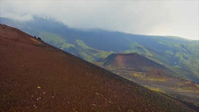 Red-brown small crater, green slopes, red slope, Crateri Silvestri, Etna, volcano, Eastern Sicily,