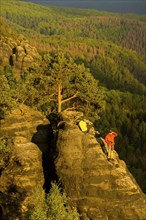 Schrammstein view in the Elbe Sandstone Mountains Looking up the Elbe. Leisurely hikers clamber