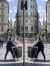 Pedestrians reflected in a shop window, Kärntner Strasse at Donnerbrunnen, Vienna, Austria, Europe