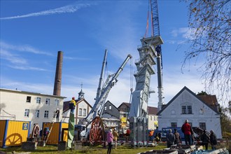 After its restoration, the 34-metre-high winding tower of the rich mine has been lifted back into