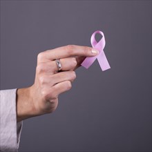 Close-up of a pink badge ribbon to support breast cancer cause