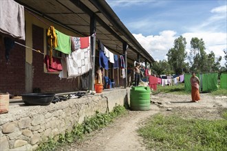 Meitei community man stays in a makeshift shelter after a mob burn their houses during an ethnic