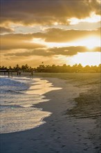 People going for a walk on sandbeach in twilight. Santa Maria. Sal. Cabo Verde. Africa