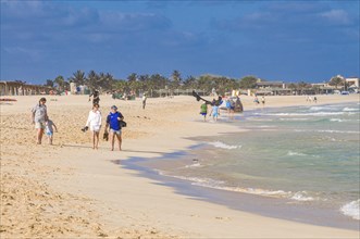 People going for a walk on nice sandbeach. Santa Maria. Sal. Cabo Verde. Africa