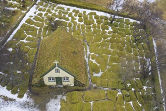 Aerial view over Hofskirkja, turf covered wooden church and cemetery at Hof in Oeraefi, Öraefi,