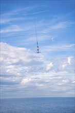 Bungy jumper on the rope over the sea, The Hague, Netherlands