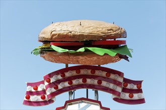 Giant hamburger, three-dimensional advertising on a fairground stall, blue sky, Düsseldorf, North