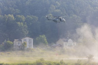 A Bundeswehr helicopter lands on the Elbe meadows in Bad Schandau on the Elbe, after a day of