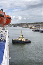 Tug, towing assistance, EDDY Tug towing the ferry King Seaways out of the harbour of Ijmuiden,