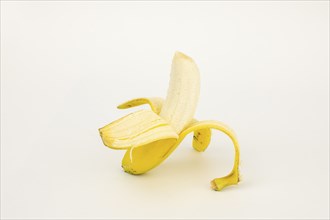 Half peeled banana, studio shot, white background, healthy diet